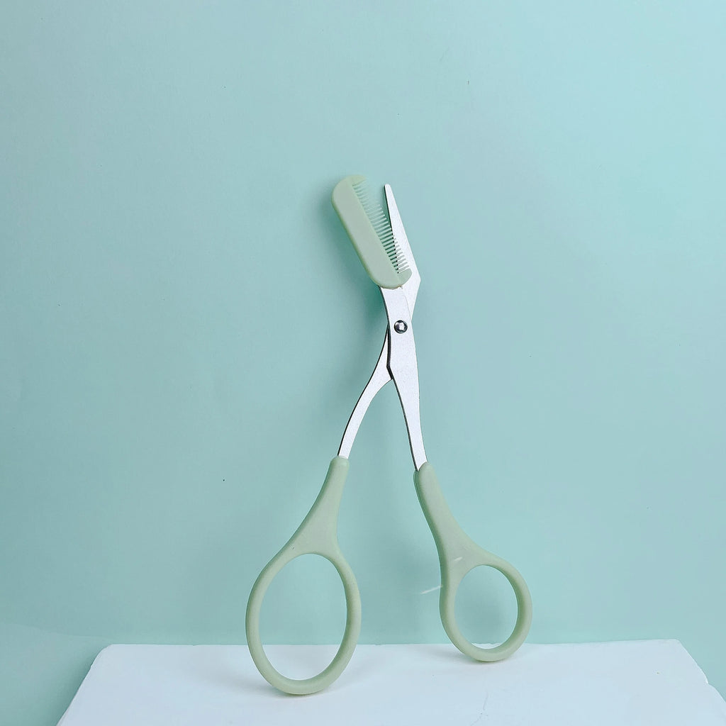 Pink eyebrow trimming scissors with built-in comb