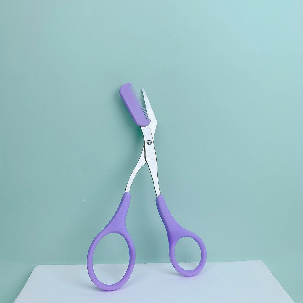 Pink eyebrow trimming scissors with built-in comb